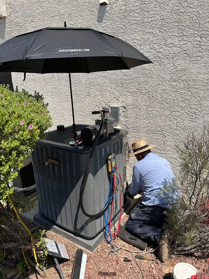 HVAC technician performing outdoor AC maintenance in Hull